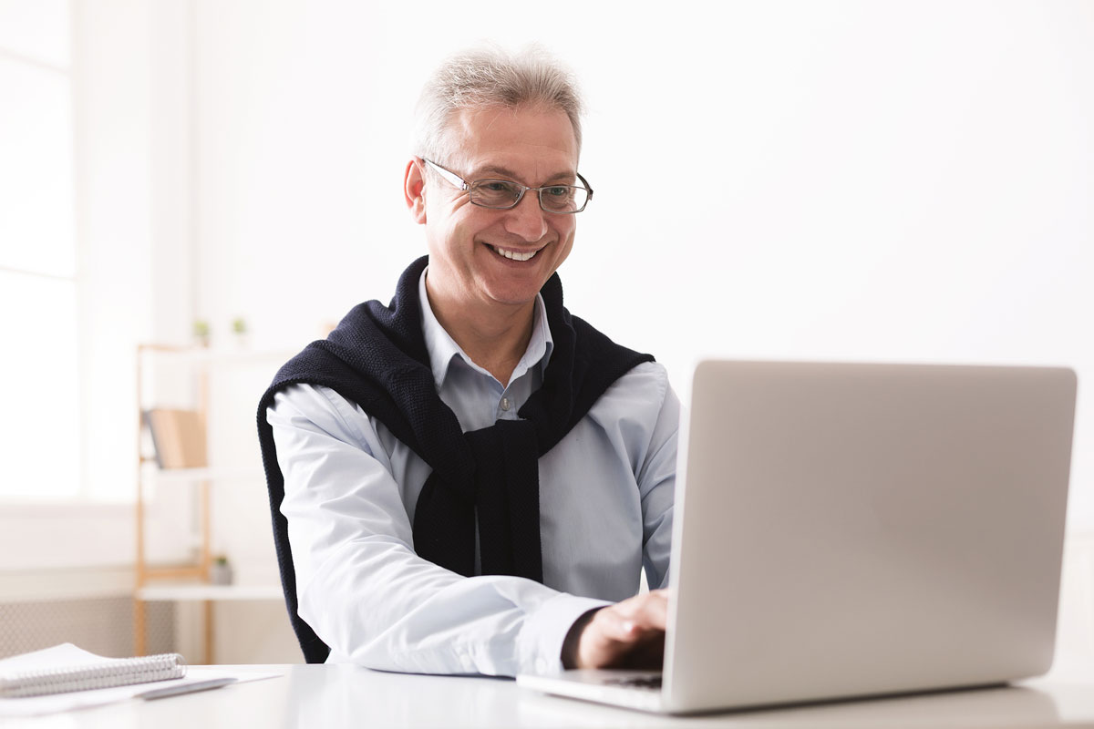Retired man doing pro bono work on computer